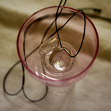 angel aura quartz stone necklace with an black cord still life image