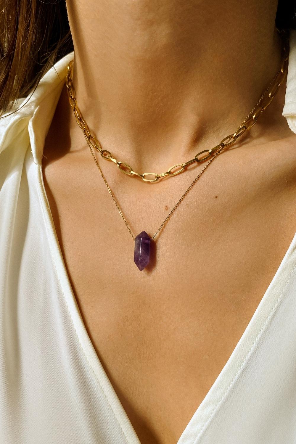 Natural Amethyst crystal necklace. The first necklace features a pointed amethyst crystal pendant, while the second necklace features a delicate gold paper clip chain. Together, the necklaces create a stunning layered look that adds sophistication and elegance to any outfit.