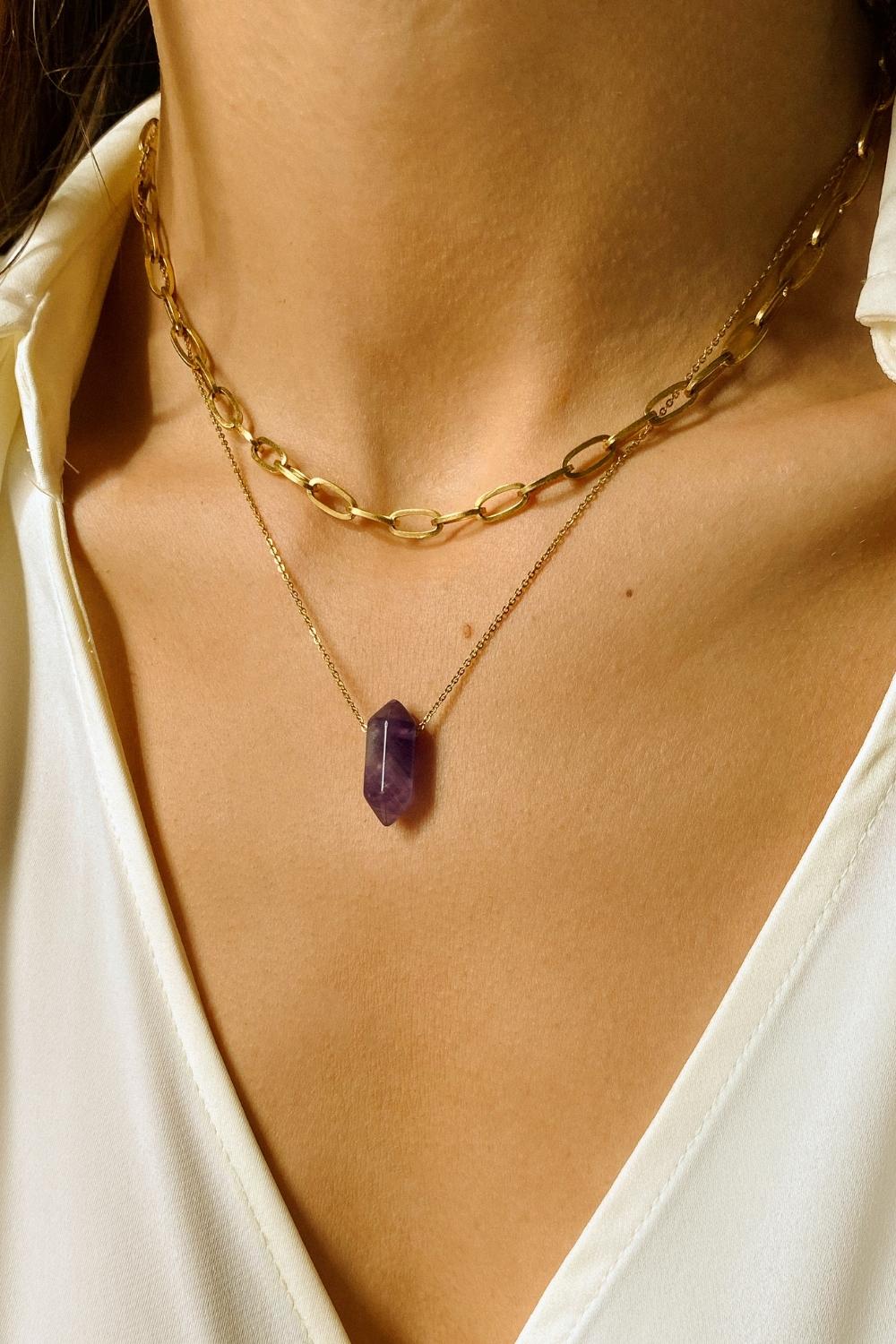 Natural Amethyst crystal necklace. The first necklace features a pointed amethyst crystal pendant, while the second necklace features a delicate gold paper clip chain. Together, the necklaces create a stunning layered look that adds sophistication and elegance to any outfit.