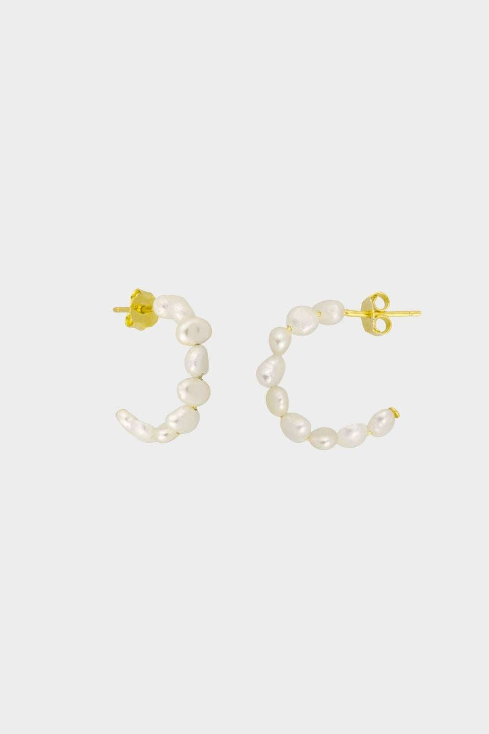 beaded pearl hoop earrings in 18k gold plated silver. The earrings feature a classic hoop design adorned with delicate beads and lustrous pearls. The gold plated silver adds a touch of elegance and sophistication to the design. The pearls are beautifully strung along the hoops, adding a timeless and glamorous element.