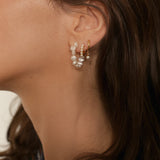 Beaded pearl hoop earrings in 18k gold plated silver. The earrings feature a classic hoop design adorned with delicate beads and lustrous pearls. The gold plated silver adds a touch of elegance and sophistication to the design. The pearls are beautifully strung along the hoops, adding a timeless and glamorous element.
