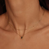 A satellite choker necklace in 18k gold plated silver. The necklace features a dainty chain with evenly spaced small beads, resembling satellites. The beads are made of gold and delicately interlinked. The necklace sits snugly around the neck, creating a trendy and minimalist look