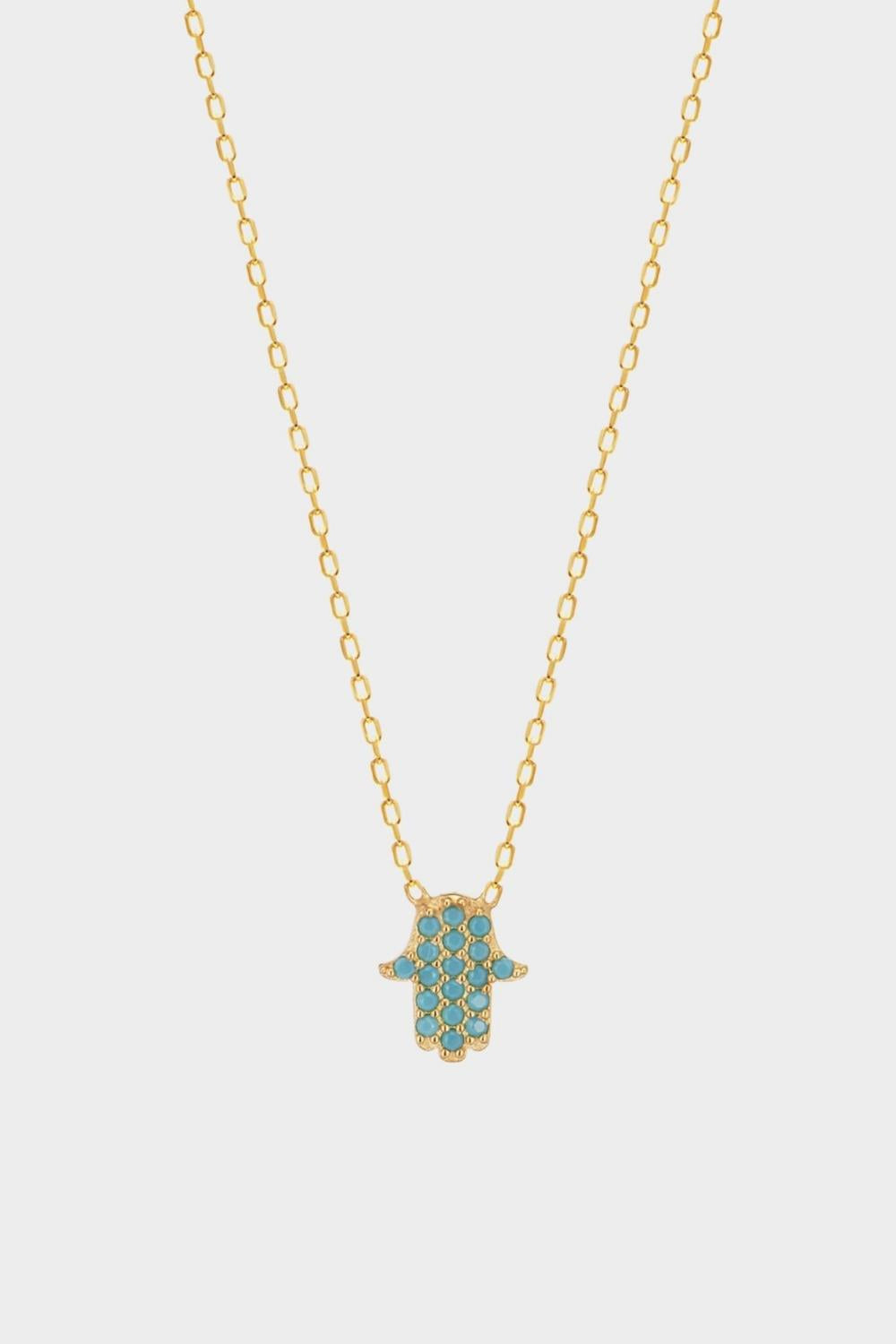 A blue Hamsa hand charm necklace in 18k gold plated silver. The necklace features a delicate chain with a beautifully designed Hamsa hand charm pendant. The Hamsa hand symbol is believed to bring protection, good luck, and ward off evil. The necklace is designed to be worn comfortably and can be adjusted to fit different neck sizes.