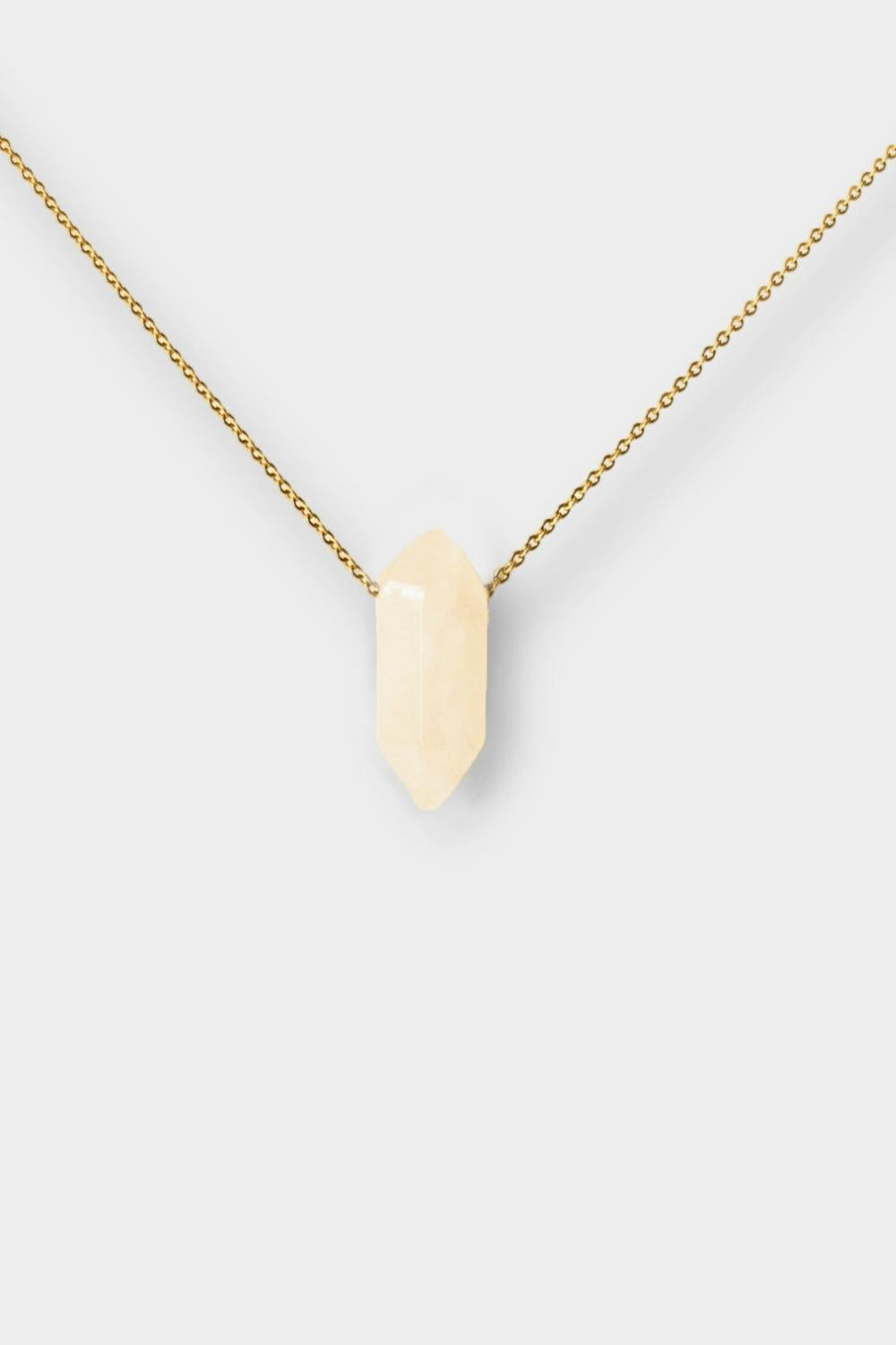 Clear Quartz crystal necklace. The necklace features a pointed clear quartz crystal pendant attached to a gold chain, creating a stunning and eye-catching piece of jewelry.