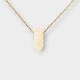 Clear Quartz crystal necklace. The necklace features a pointed clear quartz crystal pendant attached to a gold chain, creating a stunning and eye-catching piece of jewelry.