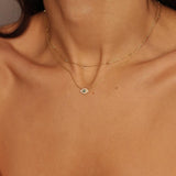 A satellite choker necklace in 18k gold plated silver. The necklace features a dainty chain with evenly spaced small beads, resembling satellites. The beads are made of gold and delicately interlinked. The necklace sits snugly around the neck, creating a trendy and minimalist look