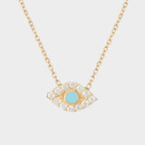 An evil eye charm necklace in 18k gold plated silver. The necklace features a delicate gold chain with an intricately designed evil eye charm pendant. The evil eye symbol is believed to provide protection against negative energies or ill-will, making this necklace both stylish and meaningful