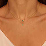 A Green Hamsa hand charm necklace in 18k gold plated silver. The necklace features a delicate chain with a beautifully designed Hamsa hand charm pendant. The Hamsa hand symbol is believed to bring protection, good luck, and ward off evil. The necklace is designed to be worn comfortably and can be adjusted to fit different neck sizes.