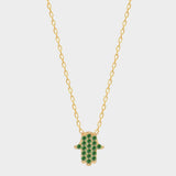 A Green Hamsa hand charm necklace in 18k gold plated silver. The necklace features a delicate chain with a beautifully designed Hamsa hand charm pendant. The Hamsa hand symbol is believed to bring protection, good luck, and ward off evil. The necklace is designed to be worn comfortably and can be adjusted to fit different neck sizes.