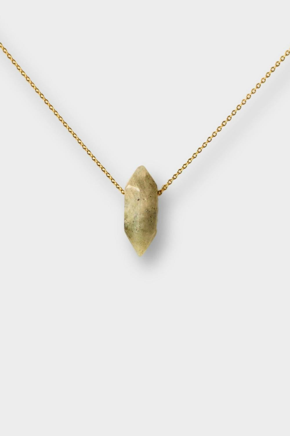 Labradorite crystal necklace. The necklace features a pointed labradorite crystal pendant attached to a gold chain, creating a stunning and eye-catching piece of jewelry.