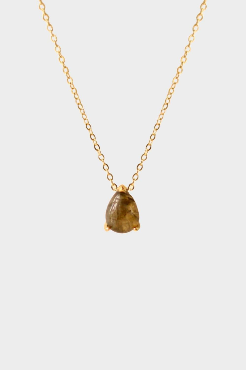 A labradorite stone pendant necklace in 18k gold plated silver. The necklace features a stunning labradorite stone pendant that is beautifully crafted and set in a gold bezel. The labradorite stone exhibits vibrant shades of grey with unique patterns, creating a captivating and natural look. The pendant is suspended from a delicate gold chain, adding elegance and sophistication to the necklace