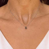 A labradorite stone pendant necklace in sterling silver. The necklace features a stunning labradorite stone pendant that is beautifully crafted and set in a silver bezel. The labradorite stone exhibits vibrant shades of grey with unique patterns, creating a captivating and natural look. The pendant is suspended from a delicate gold chain, adding elegance and sophistication to the necklace