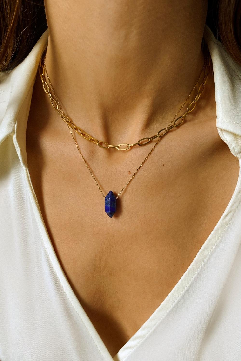 Natural Lapis lazuli crystal necklace. The first necklace features a pointed lapis lazuli crystal pendant, while the second necklace features a delicate gold paper clip chain. Together, the necklaces create a stunning layered look that adds sophistication and elegance to any outfit.