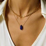 Natural Lapis lazuli crystal necklace. The first necklace features a pointed lapis lazuli crystal pendant, while the second necklace features a delicate gold paper clip chain. Together, the necklaces create a stunning layered look that adds sophistication and elegance to any outfit.