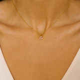 An initial pendant necklace in 18k gold plated silver. The necklace features a delicate gold chain, with a pendant in the shape of a single letter G from the alphabet. The pendant is intricately designed, showcasing the initial with a stylish and elegant font. Perfect for gifting or adding a personal touch to any outfit.