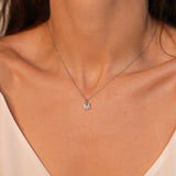 An initial pendant necklace in sterling silver. The necklace features a delicate silver chain, with a pendant in the shape of a single letter M from the alphabet. The pendant is intricately designed, showcasing the initial with a stylish and elegant font. Perfect for gifting or adding a personal touch to any outfit.