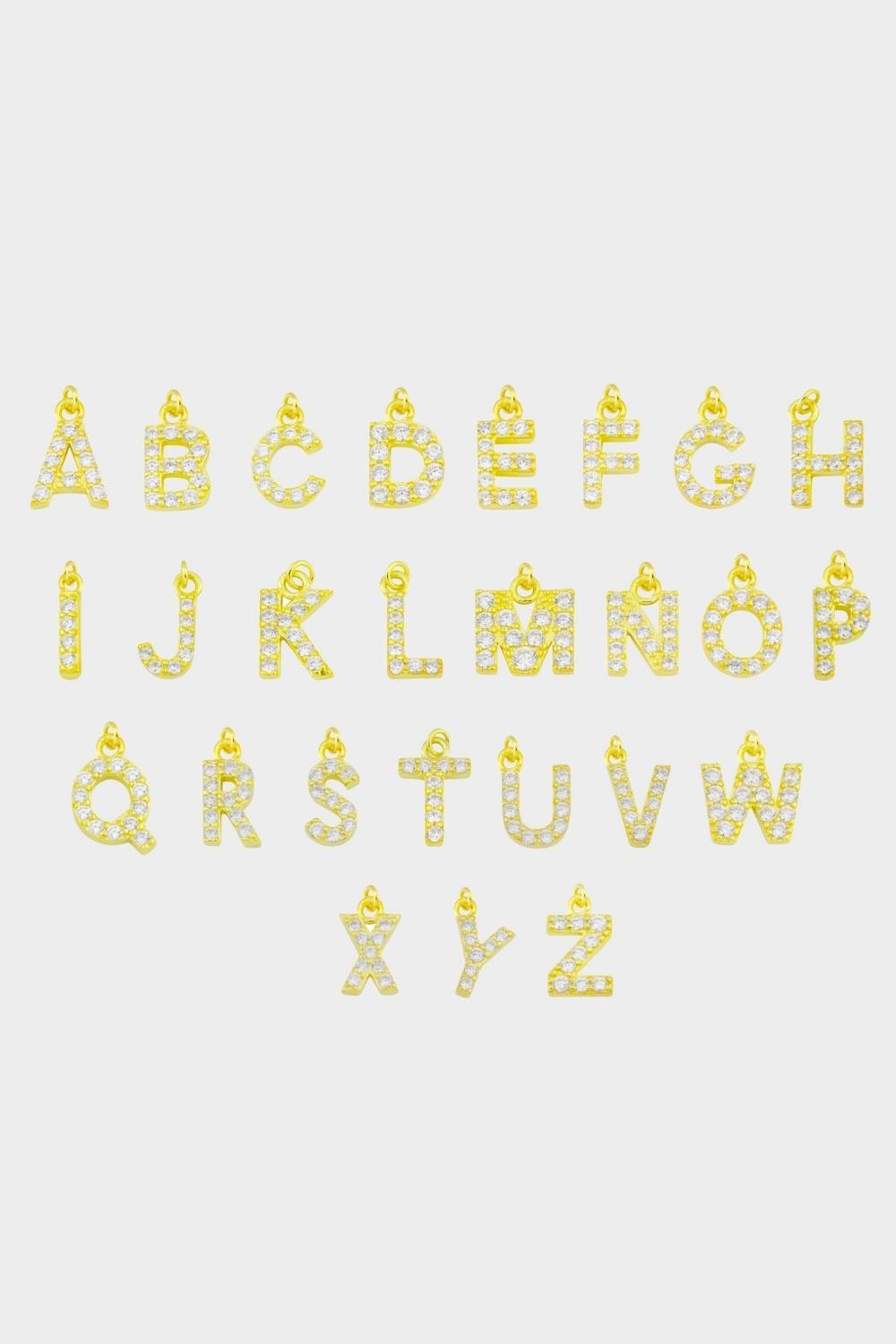 Initial pendants in 18k gold plated silver. The pendants are designed in the shape of letters of the alphabet, made with a luxurious gold material. Each pendant features a unique initial, adding a personal touch and customization to the jewelry. The gold color adds a touch of elegance and sophistication. They can be worn individually or layered with other pendants and necklaces for a trendy and personalized look.