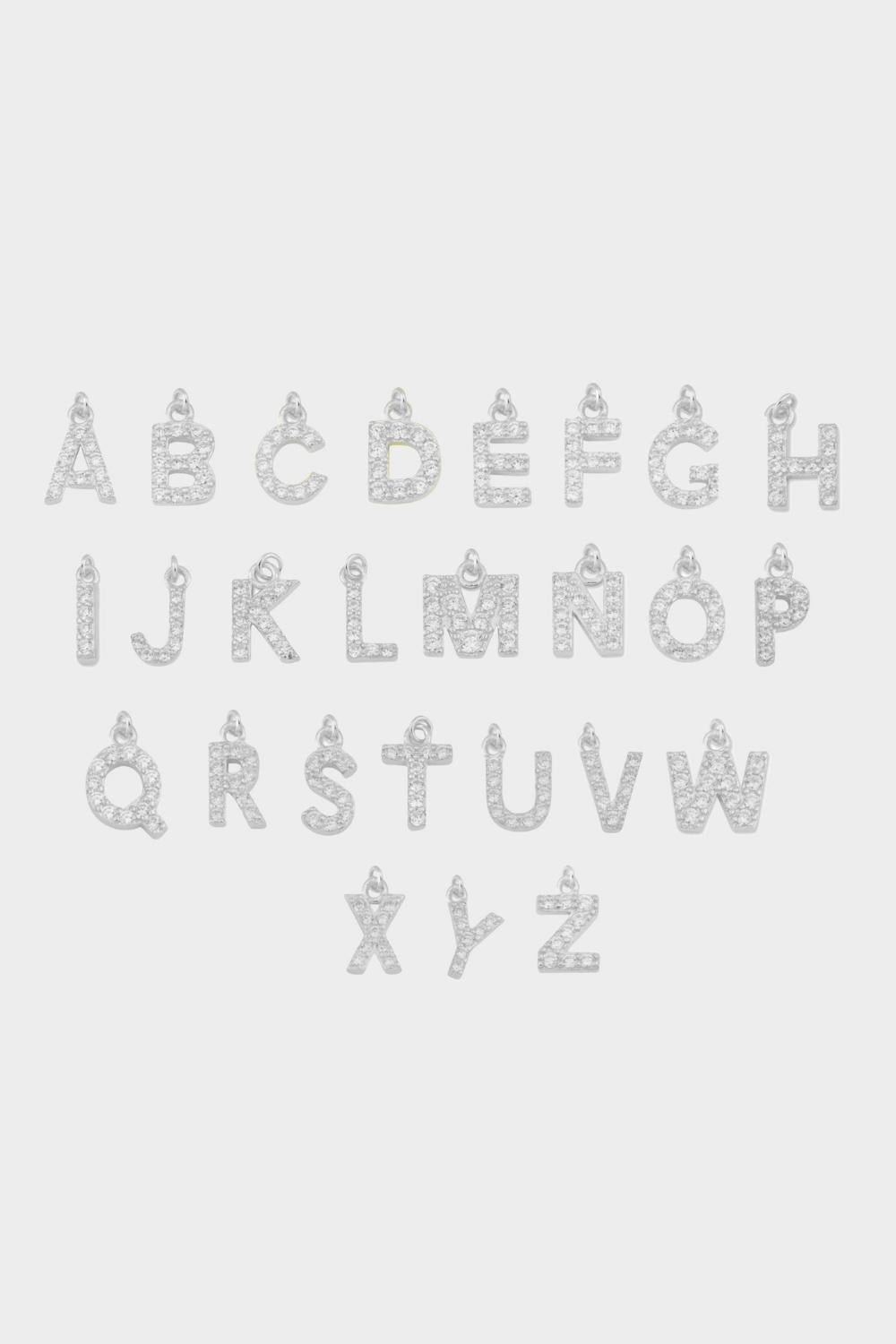Initial pendants in sterling silver. The pendants are designed in the shape of letters of the alphabet, made with a luxurious gold material. Each pendant features a unique initial, adding a personal touch and customization to the jewelry. They can be worn individually or layered with other pendants and necklaces for a trendy and personalized look.
