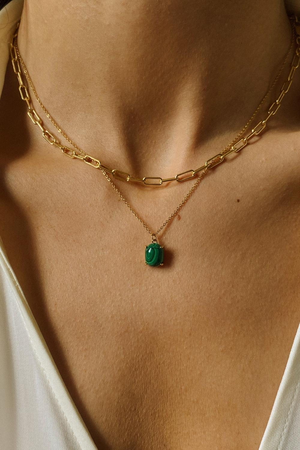 A layered necklaces set that includes a malachite stone pendant necklace and a paper clip chain in 18k gold plated silver.The set features a stunning malachite stone pendant necklace, crafted with a beautiful gold bezel and suspended from a delicate gold chain. Along with the malachite stone pendant necklace, the set also includes a stylish paper clip chain, that adds a trendy and modern touch to the jewelry collection.