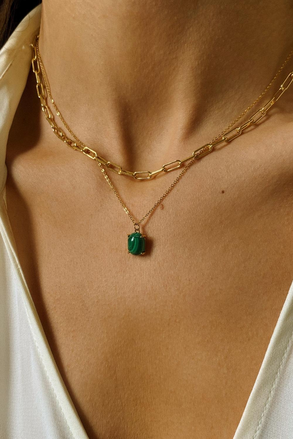 A layered necklaces set that includes a malachite stone pendant necklace and a paper clip chain in 18k gold plated silver.The set features a stunning malachite stone pendant necklace, crafted with a beautiful gold bezel and suspended from a delicate gold chain. Along with the malachite stone pendant necklace, the set also includes a stylish paper clip chain, that adds a trendy and modern touch to the jewelry collection.