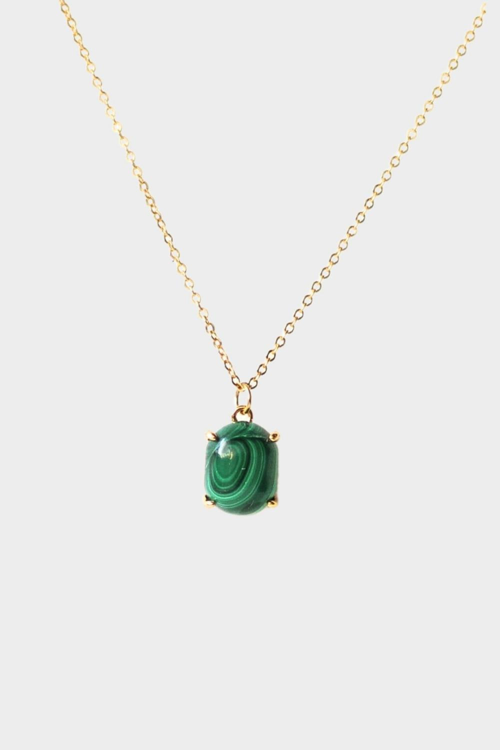 A malachite stone pendant necklace in 18k gold plated silver. The necklace features a stunning malachite stone pendant that is beautifully crafted and set in a gold bezel. The malachite stone exhibits vibrant shades of green with unique patterns, creating a captivating and natural look. The pendant is suspended from a delicate gold chain, adding elegance and sophistication to the necklace