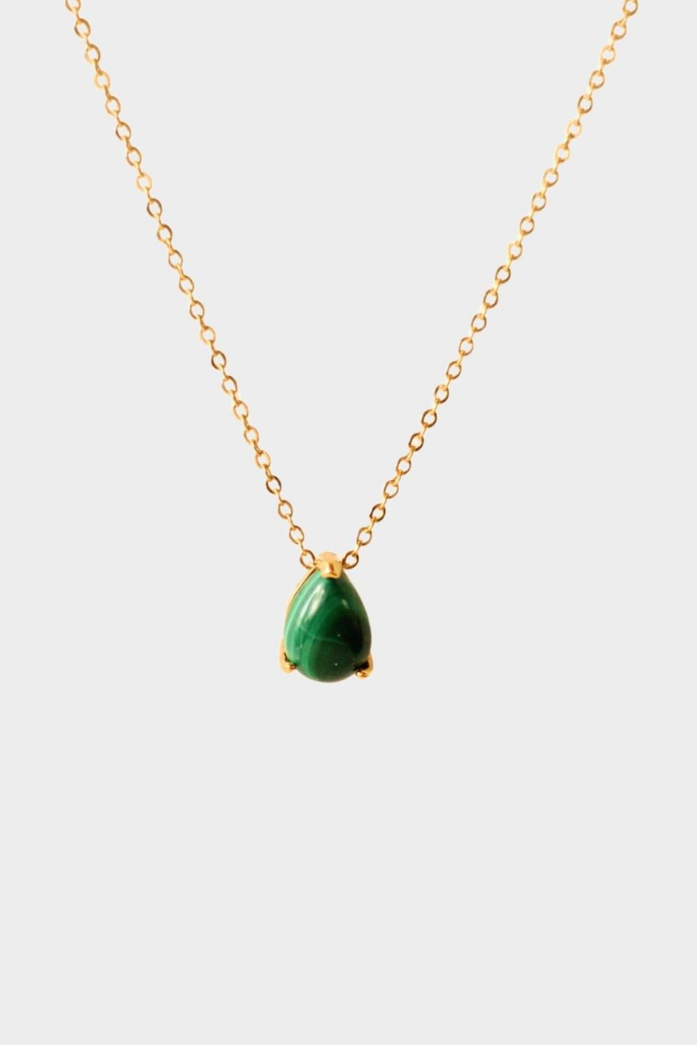 A malachite stone pendant necklace in 18k gold plated silver. The necklace features a stunning malachite stone pendant that is beautifully crafted and set in a gold bezel. The malachite stone exhibits vibrant shades of green with unique patterns, creating a captivating and natural look. The pendant is suspended from a delicate gold chain, adding elegance and sophistication to the necklace