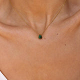 A malachite stone pendant necklace in 18k gold plated silver. The necklace features a stunning malachite stone pendant that is beautifully crafted and set in a gold bezel. The malachite stone exhibits vibrant shades of green with unique patterns, creating a captivating and natural look. The pendant is suspended from a delicate gold chain, adding elegance and sophistication to the necklace