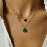A malachite stone pendant necklace in 18k gold plated silver. The necklace features a stunning malachite stone pendant that is beautifully crafted and set in a gold bezel. The malachite stone exhibits vibrant shades of green with unique patterns, creating a captivating and natural look. The pendant is suspended from a delicate gold chain, adding elegance and sophistication to the necklace