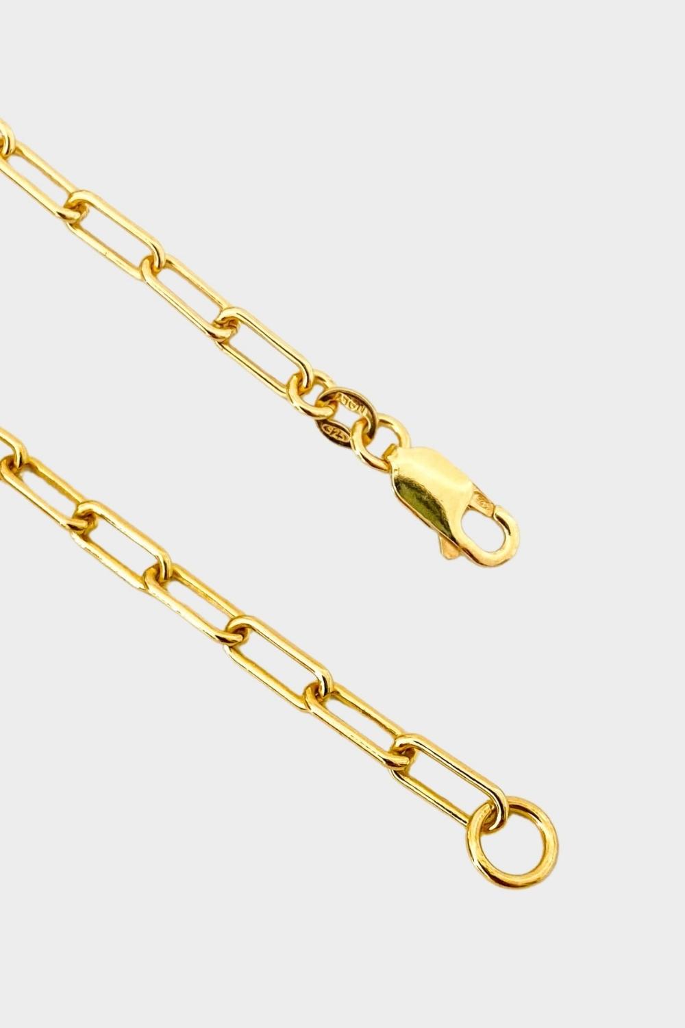 18k gold plated over sterling silver paper clip chain choker. The choker is composed of interlocking paper clip-shaped links, with each link carefully plated in 18k gold for a luxurious and radiant shine. The paper clip chain design gives the necklace a trendy and contemporary look. The choker is designed to sit comfortably around the neck, creating a stylish and fashionable accessory that can be worn alone or layered with other necklaces