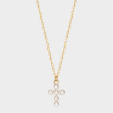 Pearl cross pendant necklace in 18k gold plated silver. The necklace features a delicate gold-plated silver chain with a pendant in the shape of a cross. The cross pendant is adorned with lustrous white pearls, adding a touch of elegance and femininity to the design. The necklace is crafted with meticulous attention to detail, creating a timeless and religious-inspired piece of jewelry. It can be worn as a symbolic accessory or as a fashionable statement piece.