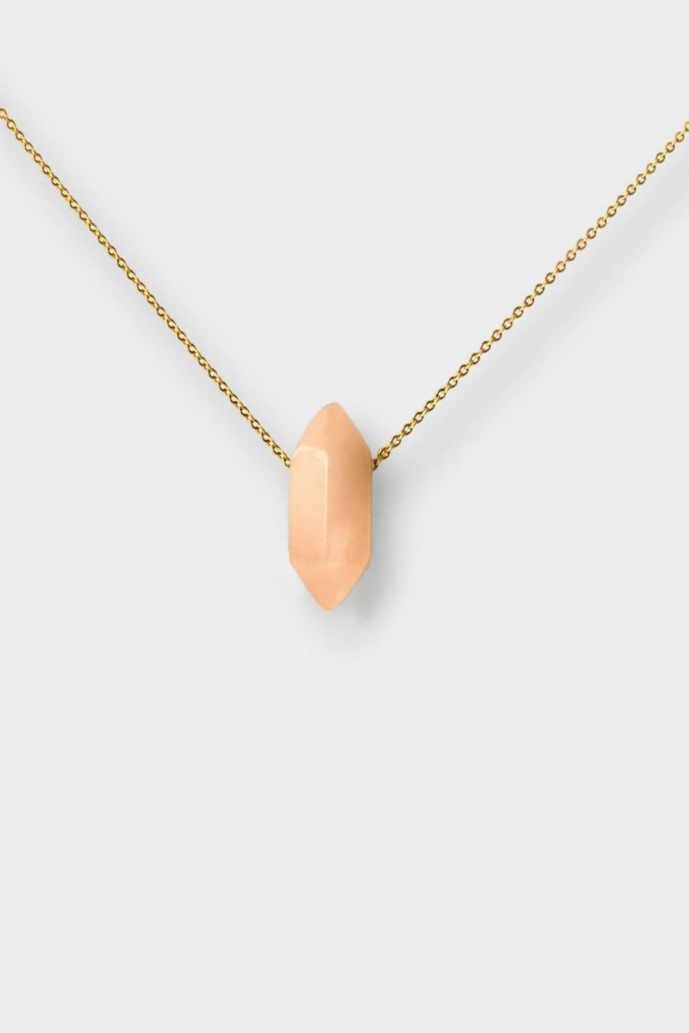 Rose quartz crystal necklace. The necklace features a pointed rose quartz crystal pendant attached to a gold chain, creating a stunning and eye-catching piece of jewelry.