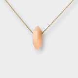 Rose quartz crystal necklace. The necklace features a pointed rose quartz crystal pendant attached to a gold chain, creating a stunning and eye-catching piece of jewelry.