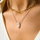 Rose Quartz crystal necklace. The first necklace features a pointed rose quartz crystal pendant, while the second necklace features a delicate gold paper clip chain. Together, the necklaces create a stunning layered look that adds sophistication and elegance to any outfit.