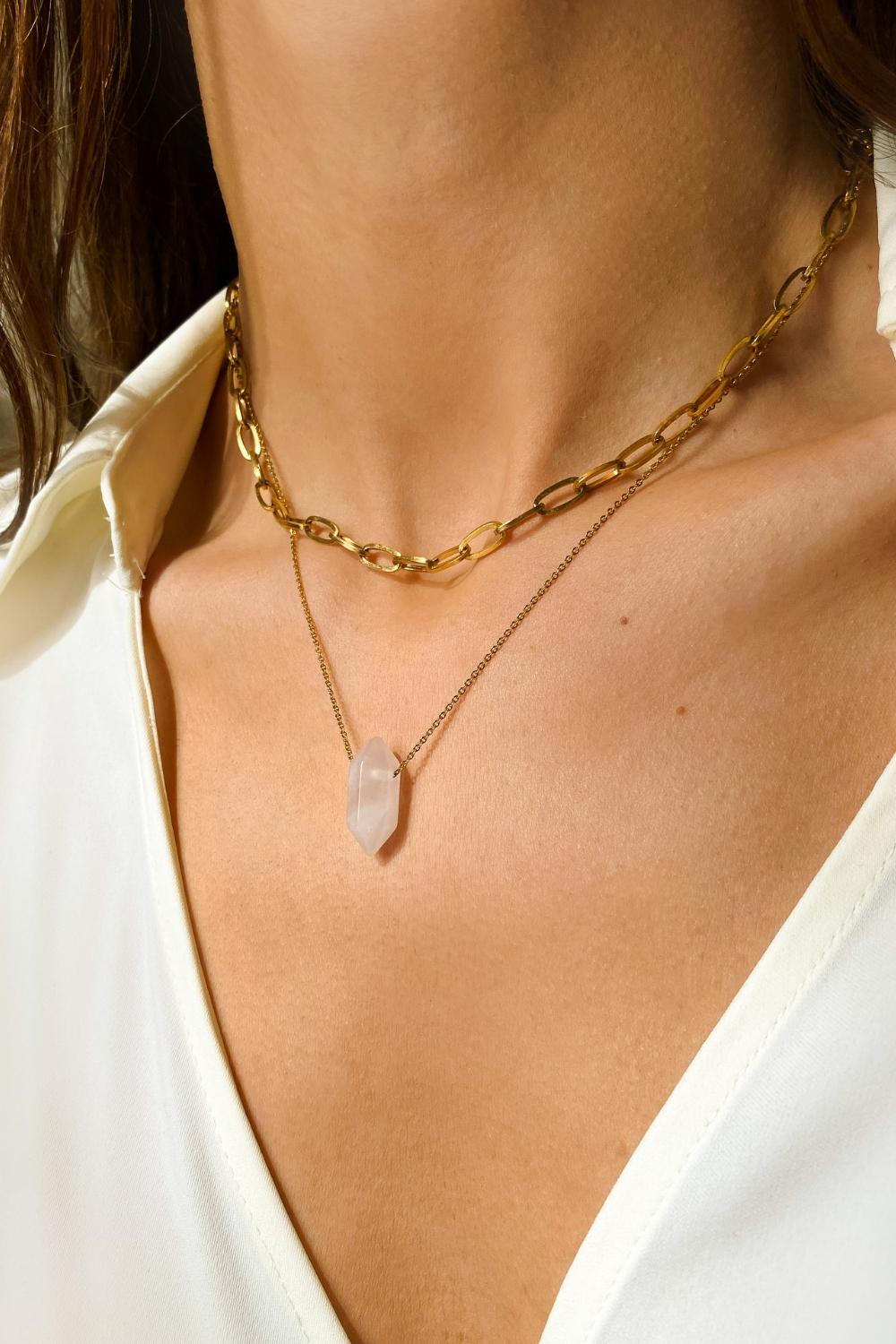 Rose Quartz crystal necklace. The first necklace features a pointed rose quartz crystal pendant, while the second necklace features a delicate gold paper clip chain. Together, the necklaces create a stunning layered look that adds sophistication and elegance to any outfit.