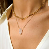 Rose Quartz crystal necklace. The first necklace features a pointed rose quartz crystal pendant, while the second necklace features a delicate gold paper clip chain. Together, the necklaces create a stunning layered look that adds sophistication and elegance to any outfit.