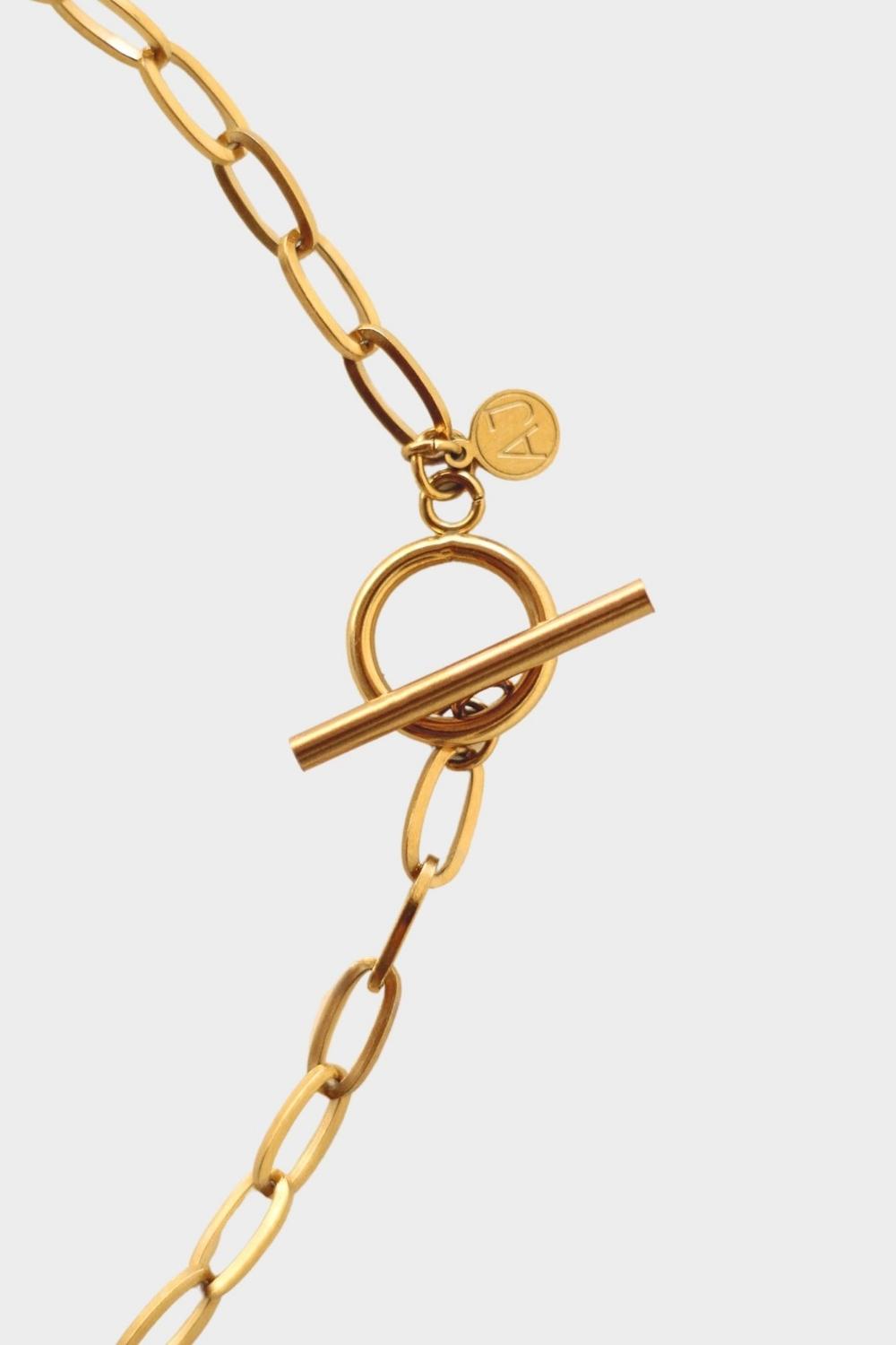 18k gold plated toggle choker necklace. The necklace features a sleek and minimalistic design, with a single chain crafted from high-quality metal and plated with 18k gold for a luxurious finish. The centerpiece of the necklace is a toggle closure, consisting of a small, decorative gold ring and a bar that fits through it to secure the necklace. This chic and elegant accessory adds a touch of sophistication to any outfit