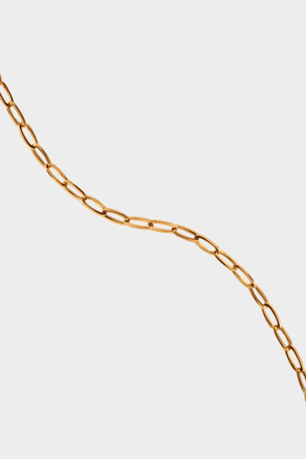 18k gold plated toggle choker necklace. The necklace features a sleek and minimalistic design, with a single chain crafted from high-quality metal and plated with 18k gold for a luxurious finish. The centerpiece of the necklace is a toggle closure, consisting of a small, decorative gold ring and a bar that fits through it to secure the necklace. This chic and elegant accessory adds a touch of sophistication to any outfit