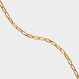 18k gold plated toggle choker necklace. The necklace features a sleek and minimalistic design, with a single chain crafted from high-quality metal and plated with 18k gold for a luxurious finish. The centerpiece of the necklace is a toggle closure, consisting of a small, decorative gold ring and a bar that fits through it to secure the necklace. This chic and elegant accessory adds a touch of sophistication to any outfit