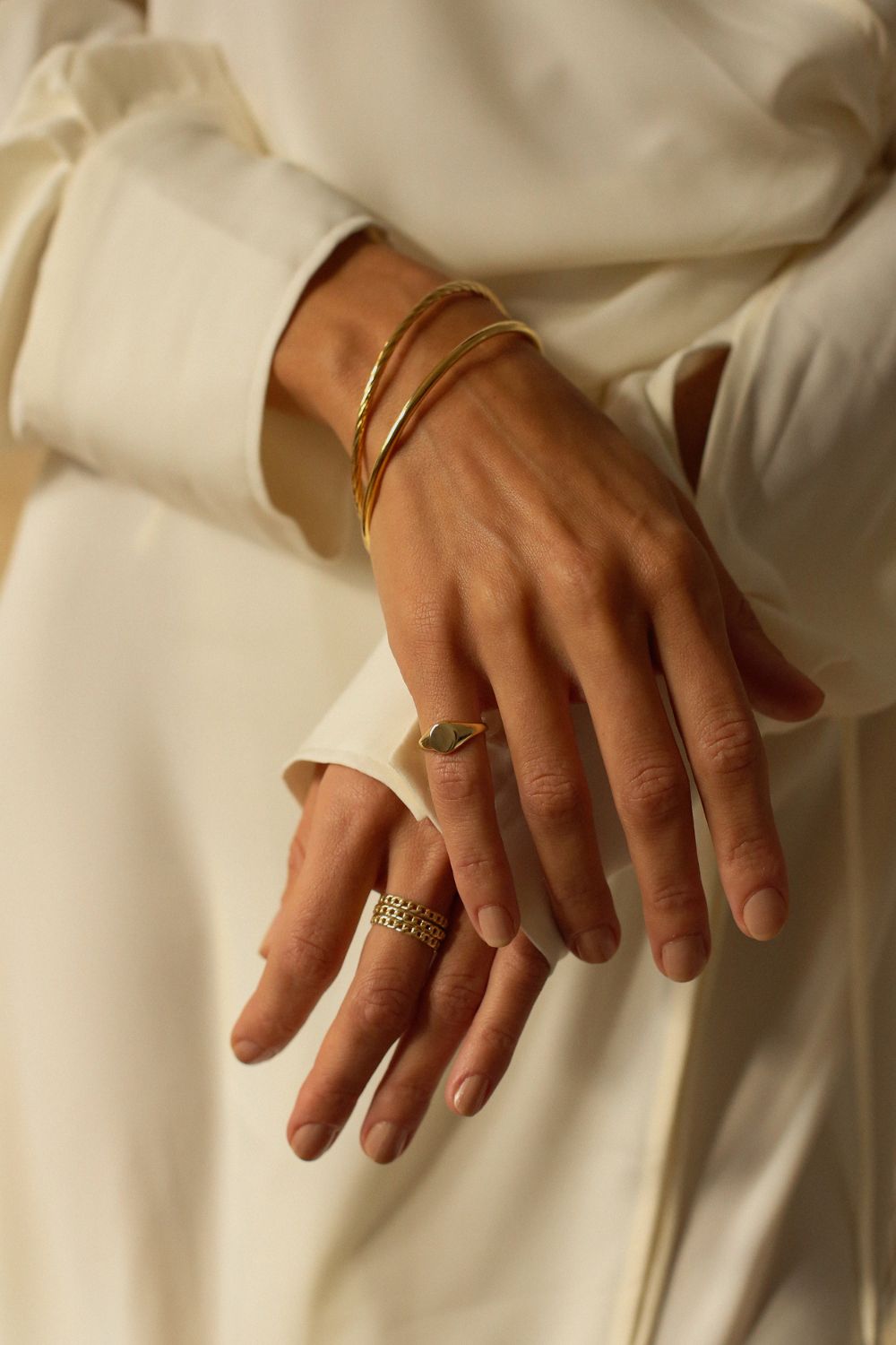 a 18k gold vermeil cuff bracelet with a round shape. The bracelet is made entirely of silver, with a smooth and polished finish. This versatile 18k gold vermeil cuff bracelet adds a touch of elegance and sophistication to any wrist.