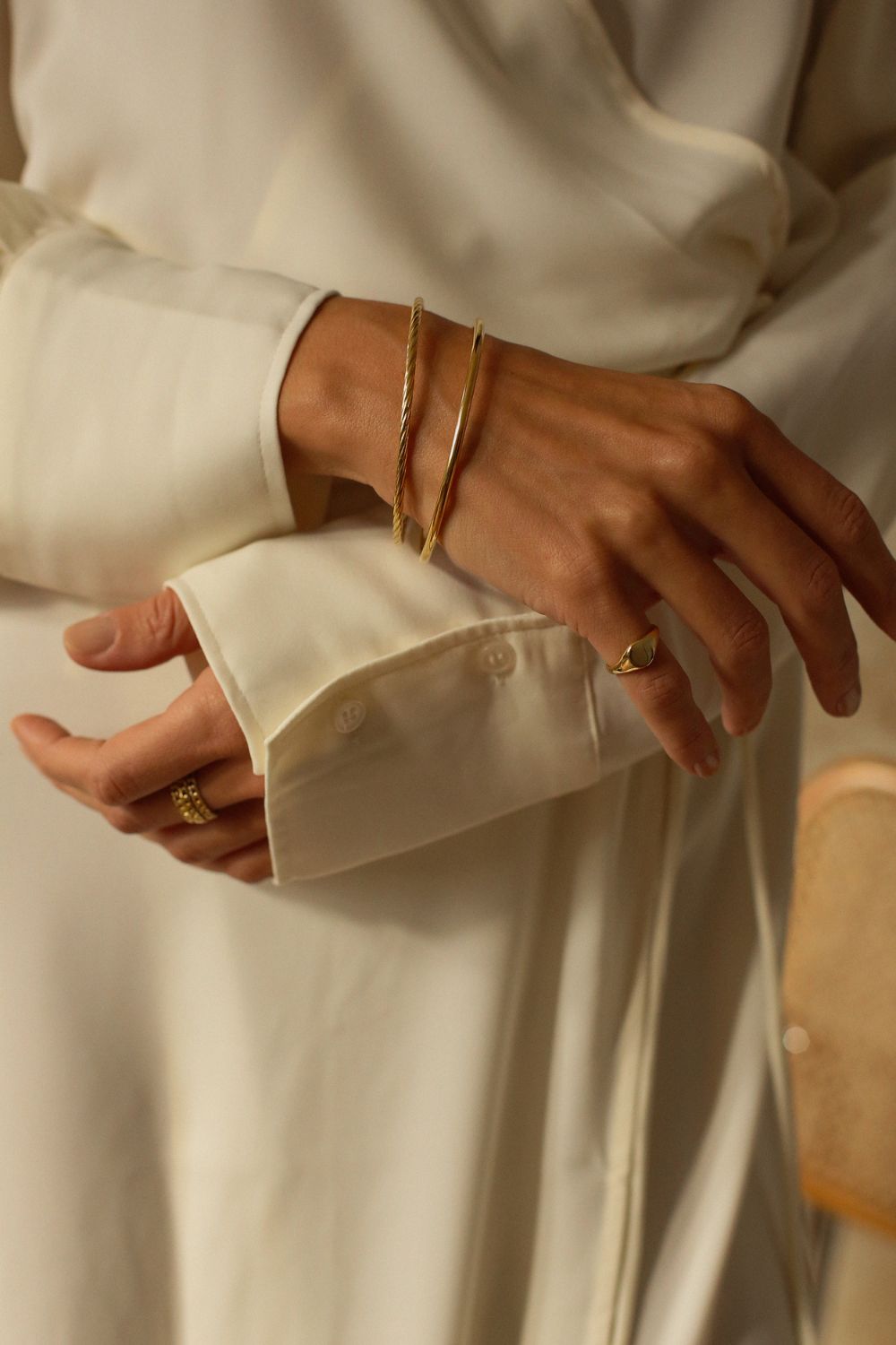 a 18k gold vermeil cuff bracelet with a round shape. The bracelet is made entirely of silver, with a smooth and polished finish. This versatile 18k gold vermeil cuff bracelet adds a touch of elegance and sophistication to any wrist.