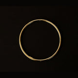 a 18k gold vermeil cuff bracelet with a round shape. The bracelet is made entirely of silver, with a smooth and polished finish. This versatile 18k gold vermeil cuff bracelet adds a touch of elegance and sophistication to any wrist.