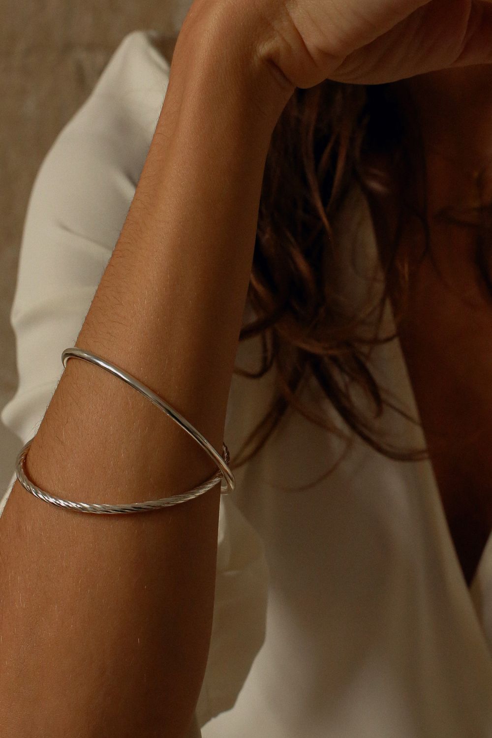 a silver cuff bracelet with a round shape. The bracelet is made entirely of silver, with a smooth and polished finish. This versatile silver cuff bracelet adds a touch of elegance and sophistication to any wrist.
