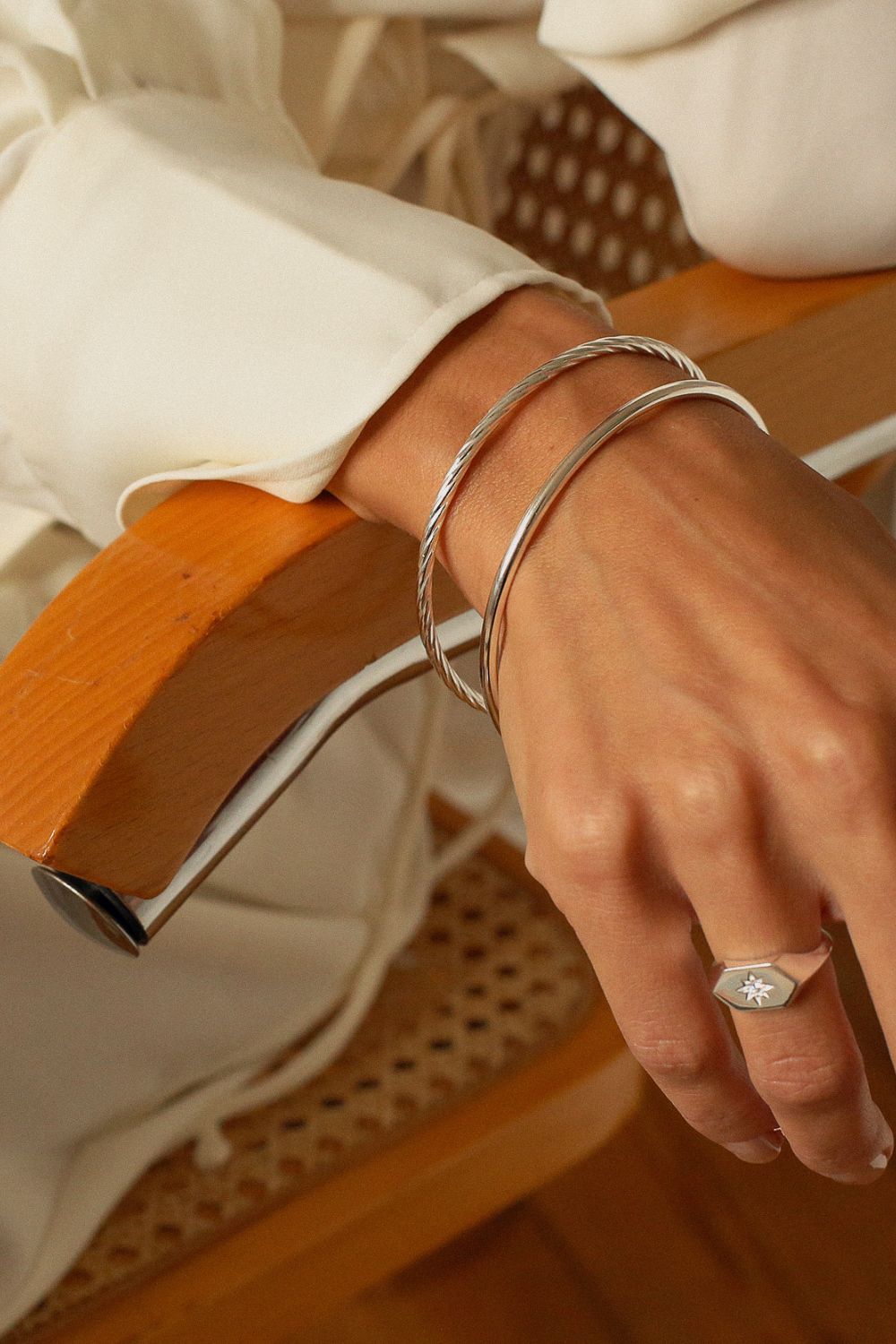 a silver cuff bracelet with a round shape. The bracelet is made entirely of silver, with a smooth and polished finish. This versatile silver cuff bracelet adds a touch of elegance and sophistication to any wrist.