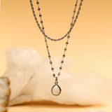 Necklace with a pendant on a beige background