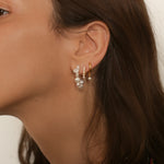 Beaded pearl hoop earrings in 18k gold plated silver. The earrings feature a classic hoop design adorned with delicate beads and lustrous pearls. The gold plated silver adds a touch of elegance and sophistication to the design. The pearls are beautifully strung along the hoops, adding a timeless and glamorous element.