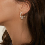 Beaded pearl hoop earrings in 18k gold plated silver. The earrings feature a classic hoop design adorned with delicate beads and lustrous pearls. The gold plated silver adds a touch of elegance and sophistication to the design. The pearls are beautifully strung along the hoops, adding a timeless and glamorous element.