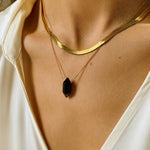 Black obsidian crystal necklace. The first necklace features a pointed black obsidian crystal pendant, while the second necklace features a delicate gold snake chain. Together, the necklaces create a stunning layered look that adds sophistication and elegance to any outfit.