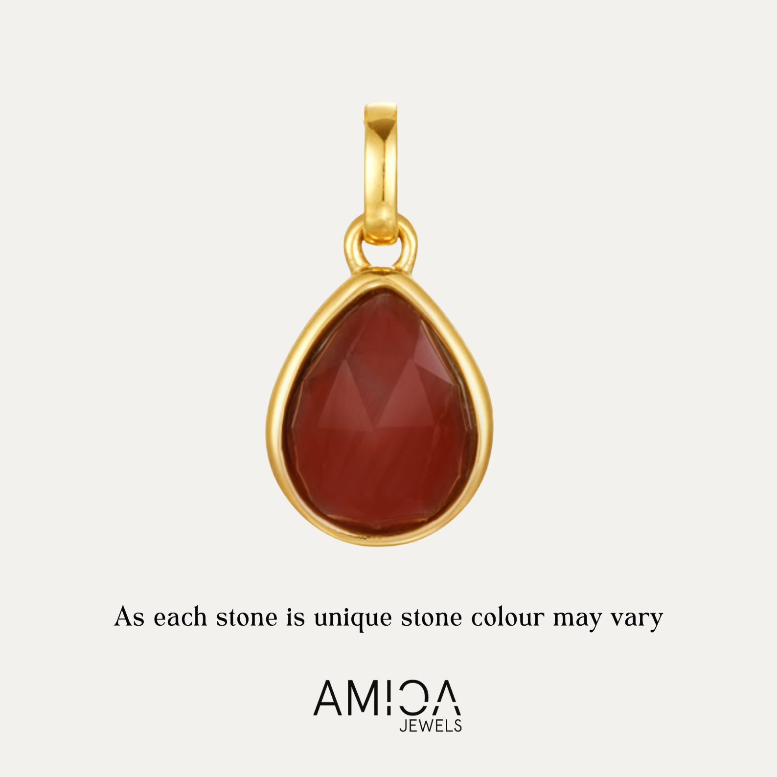 Gold pendant with a red stone on a light beige background, featuring the AMICA Jewels brand.