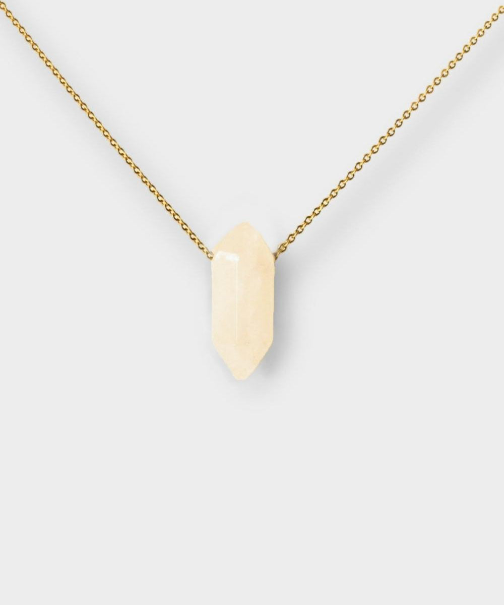 Clear Quartz crystal necklace. The necklace features a pointed clear quartz crystal pendant attached to a gold chain, creating a stunning and eye-catching piece of jewelry.