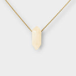 Clear Quartz crystal necklace. The necklace features a pointed clear quartz crystal pendant attached to a gold chain, creating a stunning and eye-catching piece of jewelry.